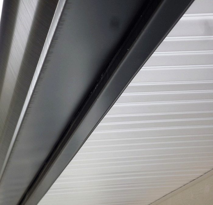 The fascia board is the long, straight board that runs along the lower edge of the roof.